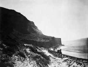 black and white photo of a railroad along the Columbia River